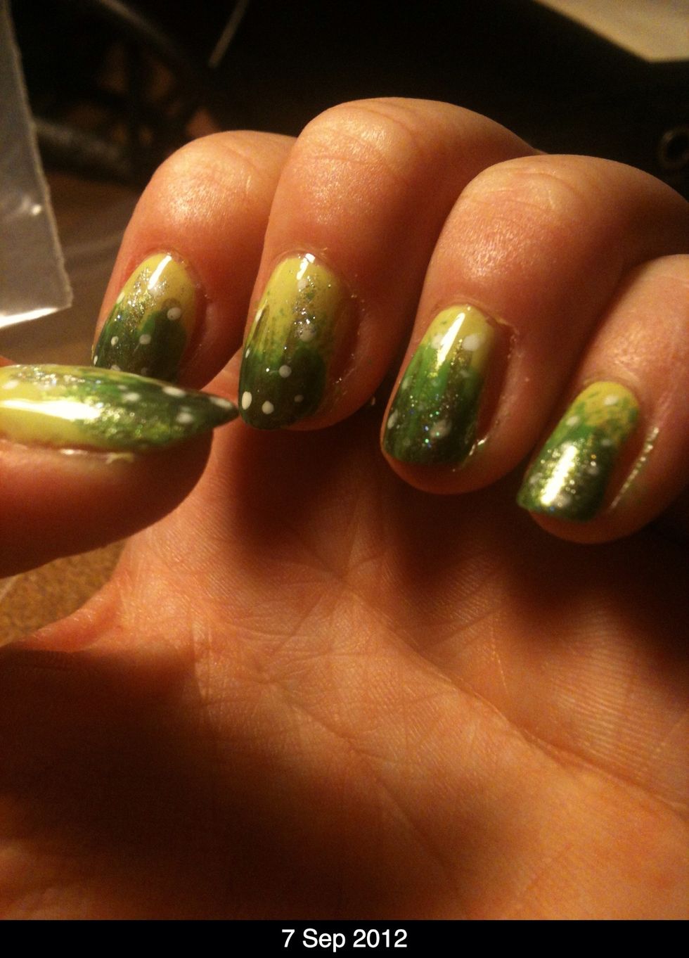 To finish just paint over a top coat or a very fine glitter/shimmer gold colour, something that won't cover up the design too much. I've used a very fine, practically clear goldy polish.
