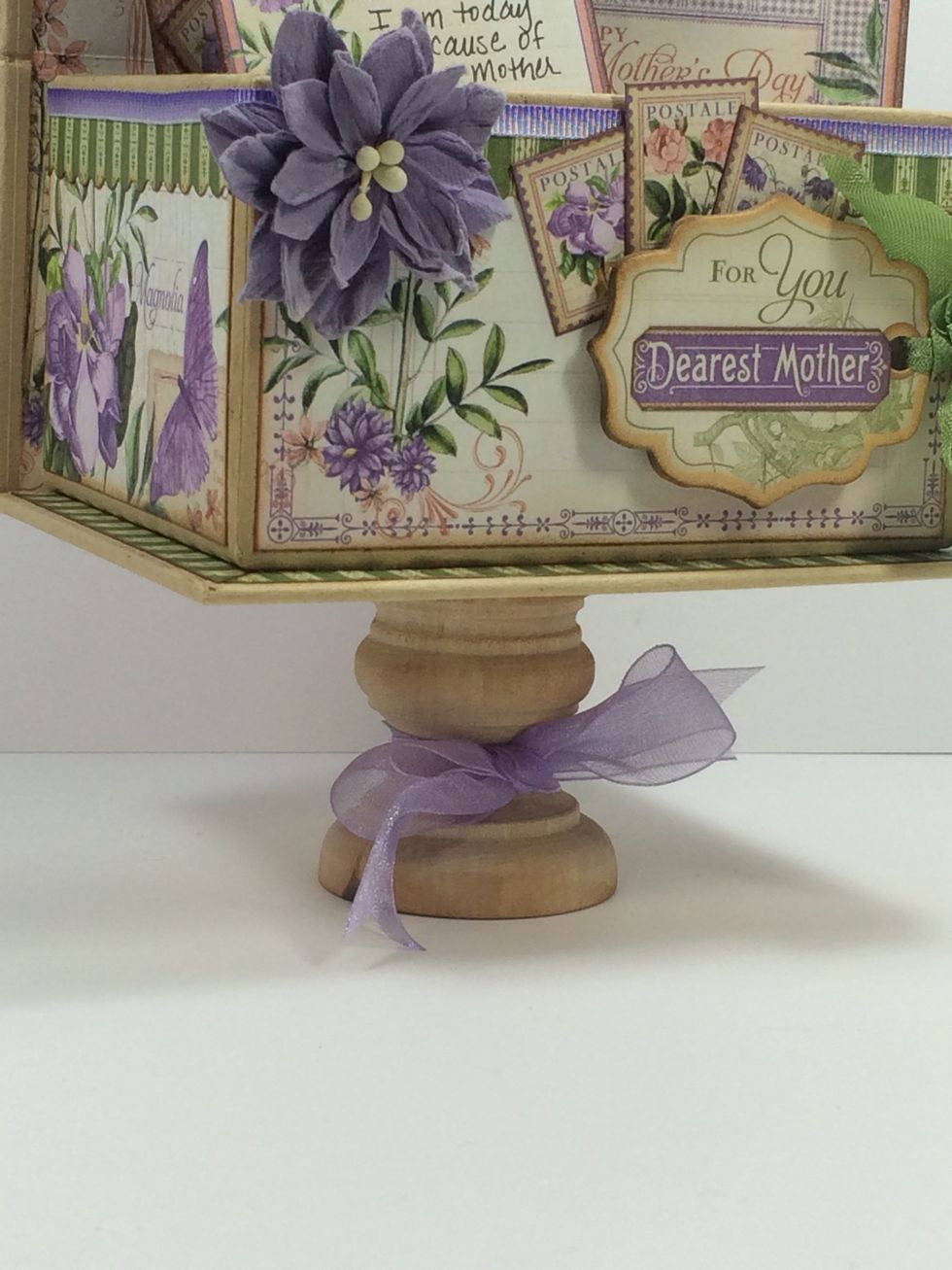 To finish off the display box, you can hot glue a wooden base to the bottom. (I got one at my local craft store). Tie a pretty ribbon around it to dress it up. I used May Arts sheer lavender ribbon.