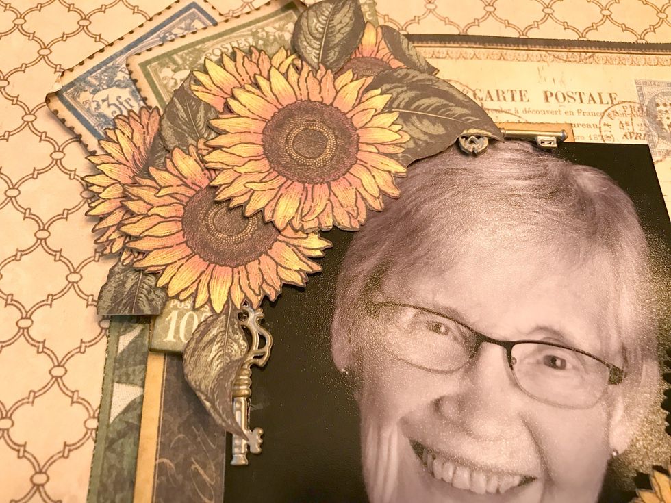 To finish off the top left hand corner with the sunflowers and stamps, adhere two shabby chic ornate metal keys.