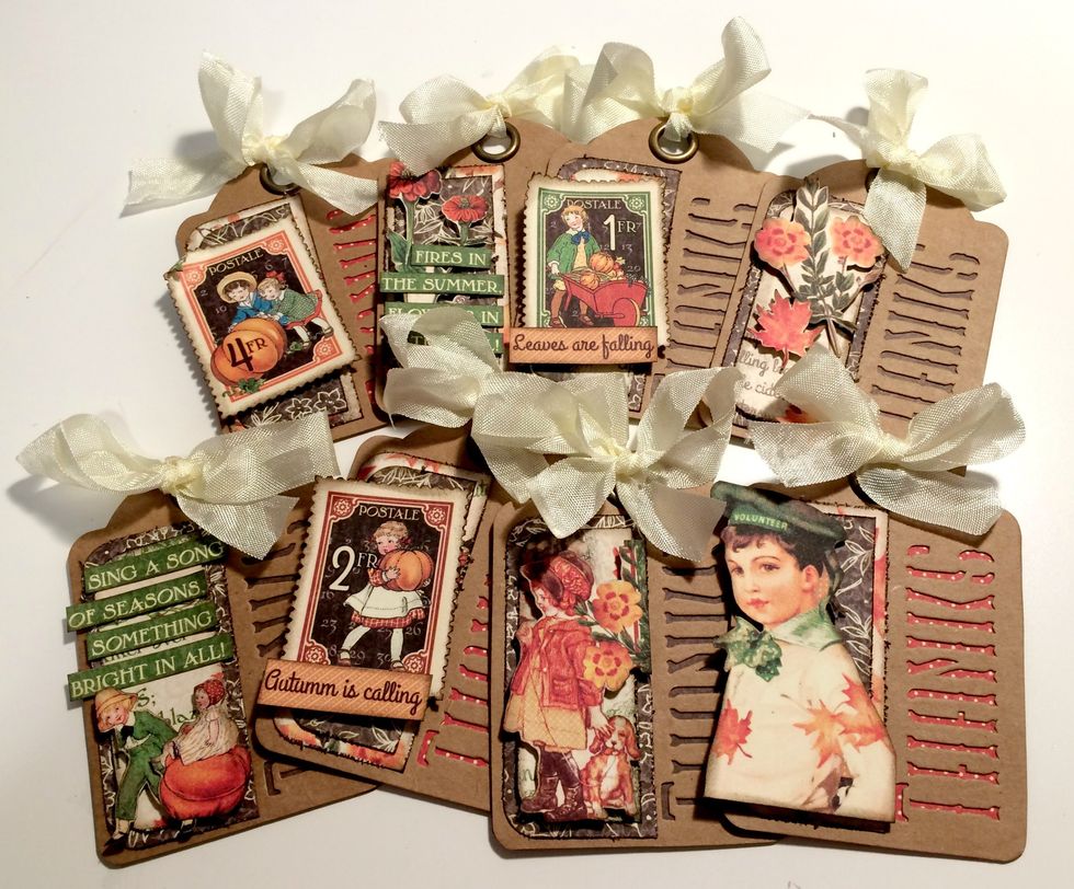 To finish the eight tags, tie a cream bow at the top of each tag. Once you've finished adding the cream ribbon to the top of the tags, your tags are complete.