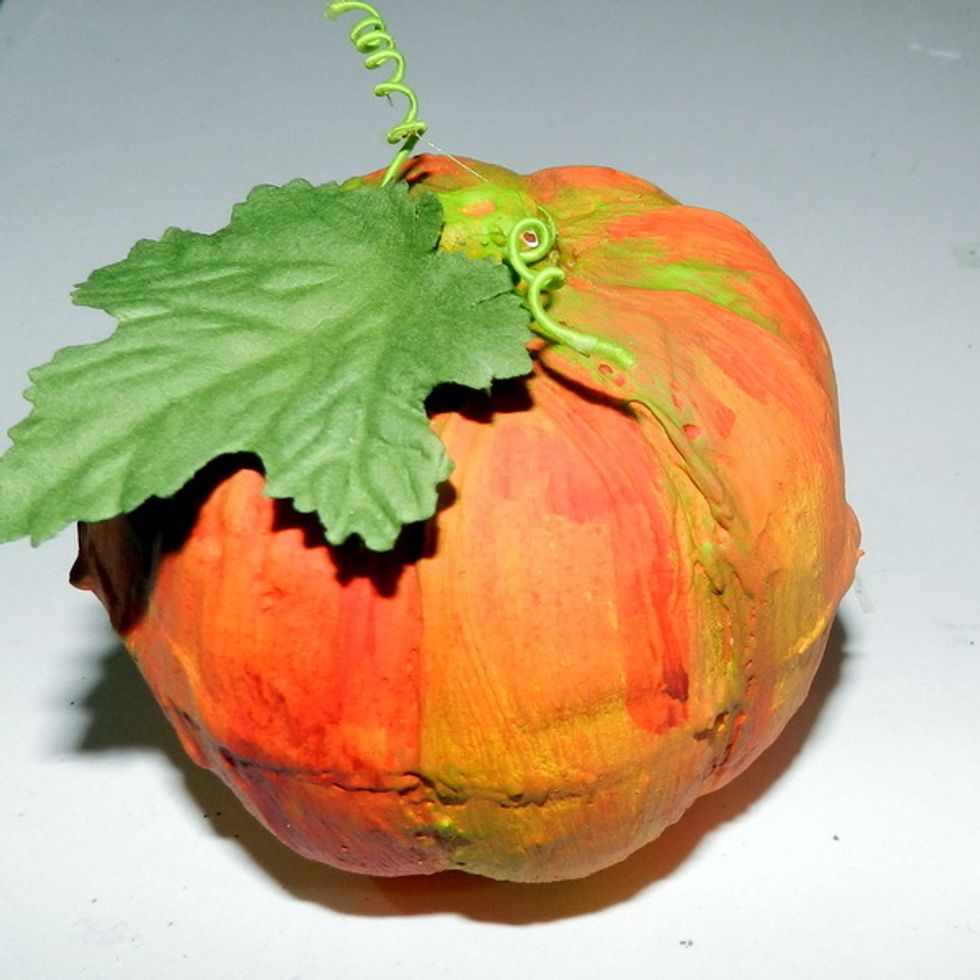 To finish the pumpkin, adhere a leaf.