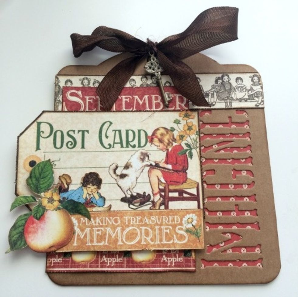 To finish the tag, use brown twine to tie the key to the middle of the bow. Your tag is now complete!