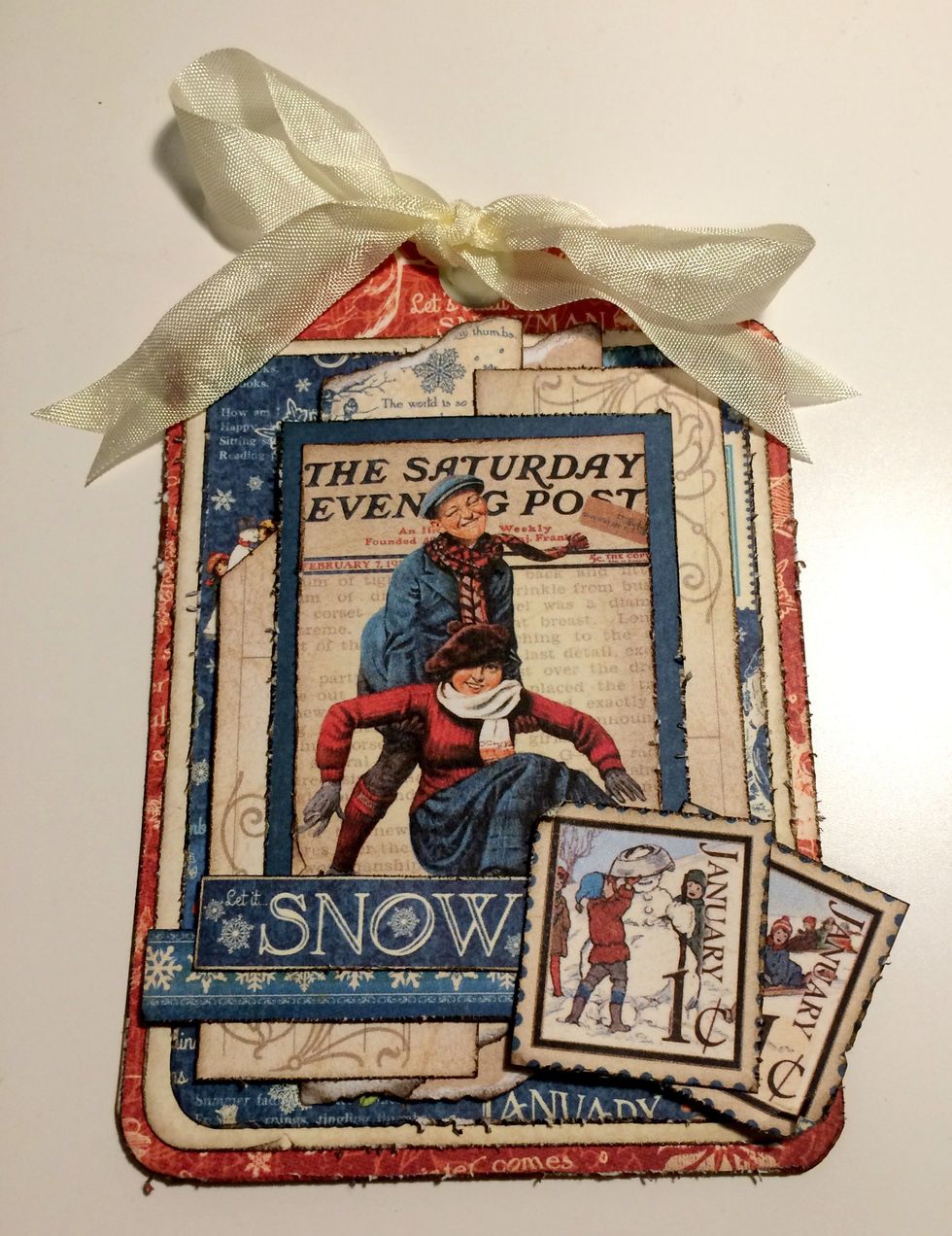 To finish your second winter tag, add a cream bow at the top of the tag. Your winter tags are now complete.