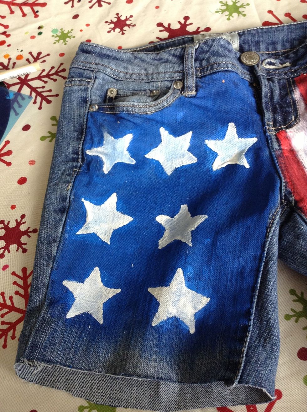 To fix my deformed stars, I used a small paintbrush to touch them up. Also, on the other side, I touched up the stripes.