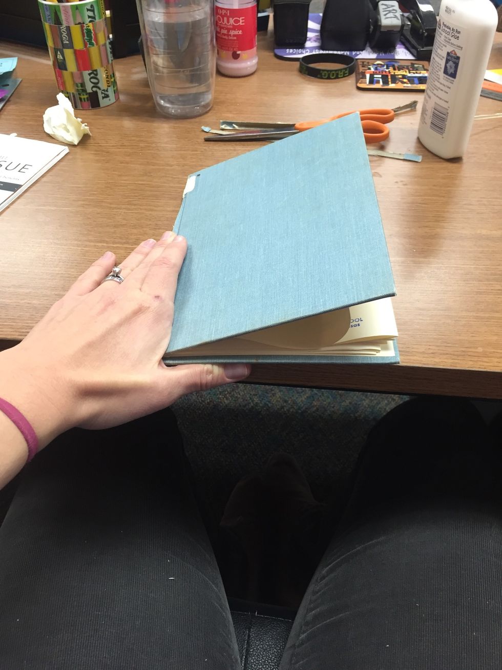 To fix that, I'll just line up the edge of the spine and fold all of the pages to fit. See that page that is curled up? It will be flattened out.
