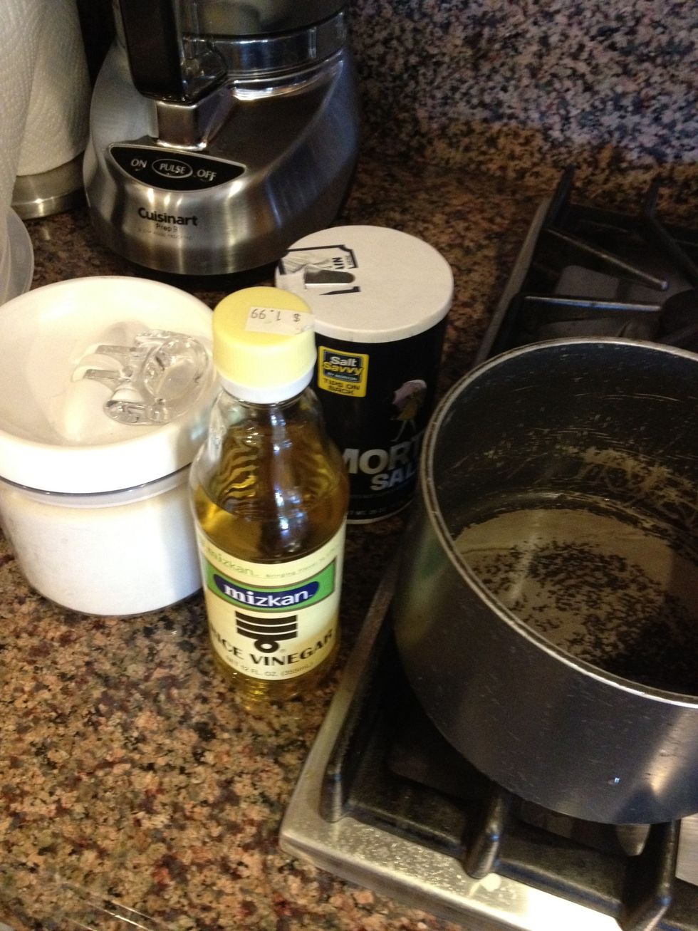 To flavor the rice, heat the rice vinegar, sugar, and salt in a small saucepan until sugar dissolves. Pour half onto rice and mix in. Rice that's too moist already may not need the second half.