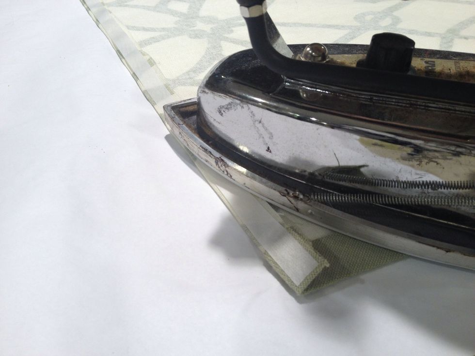 To form a heading at the top of the shade, press down 1/2" toward the wrong side of the shade. Apply steam-a-seam to the fold.