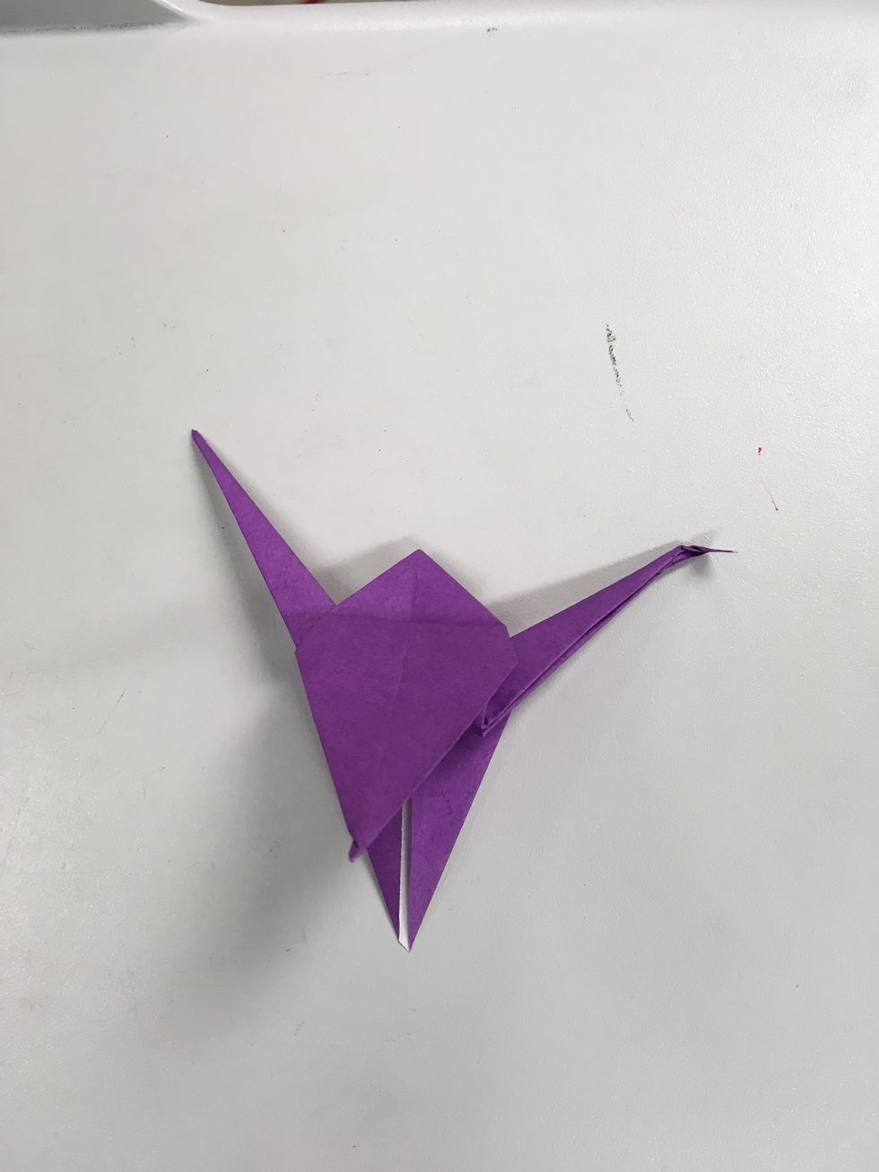 To form the head, bend one of the tips of thinner triangles downward at an angle.