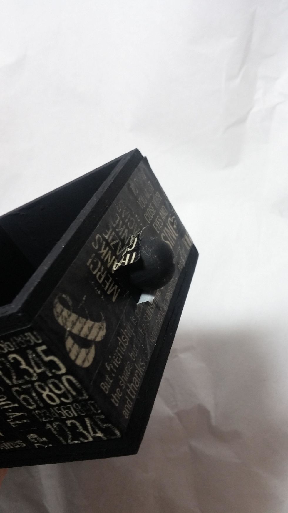 To get around the knob I simply cut some slits and trimmed the tape away. I tried to remove the knob to use different hardware and avoid this issue, but I could not get it off!