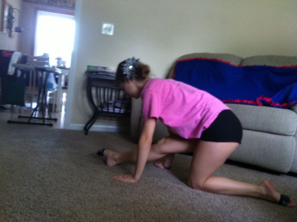 To get in your splits put both hands on each side of your leg. Push your front leg out so it is straight and then push your back leg straight behind you. Make sure you keep your hips facing forward