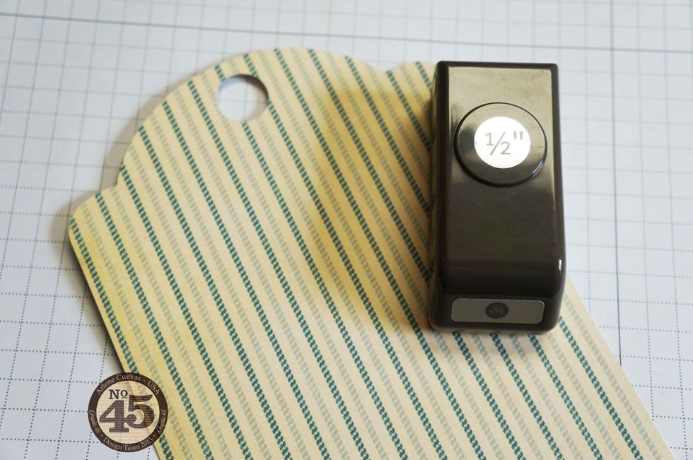 To get the design paper around the pre-installed grommet of the tag, use a \u00bd\u201d circle punch (I purchased mine through Stampin\u2019 Up).