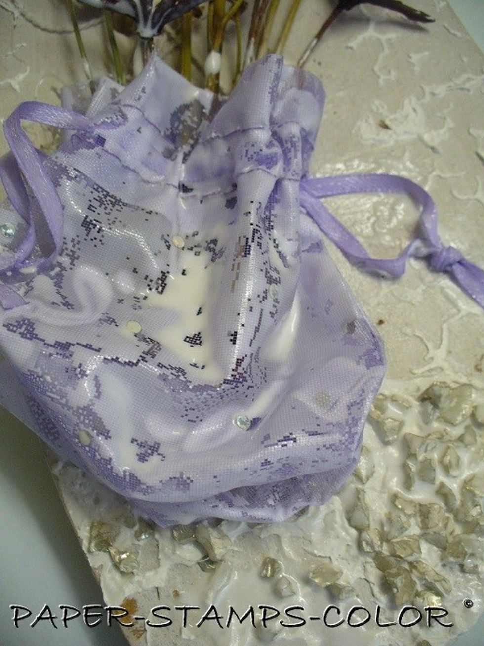 To harden the 'bag', paint it with a mixture of white glue, gesso and water. You might want to do multiple layers, drying it inbetween each layer.