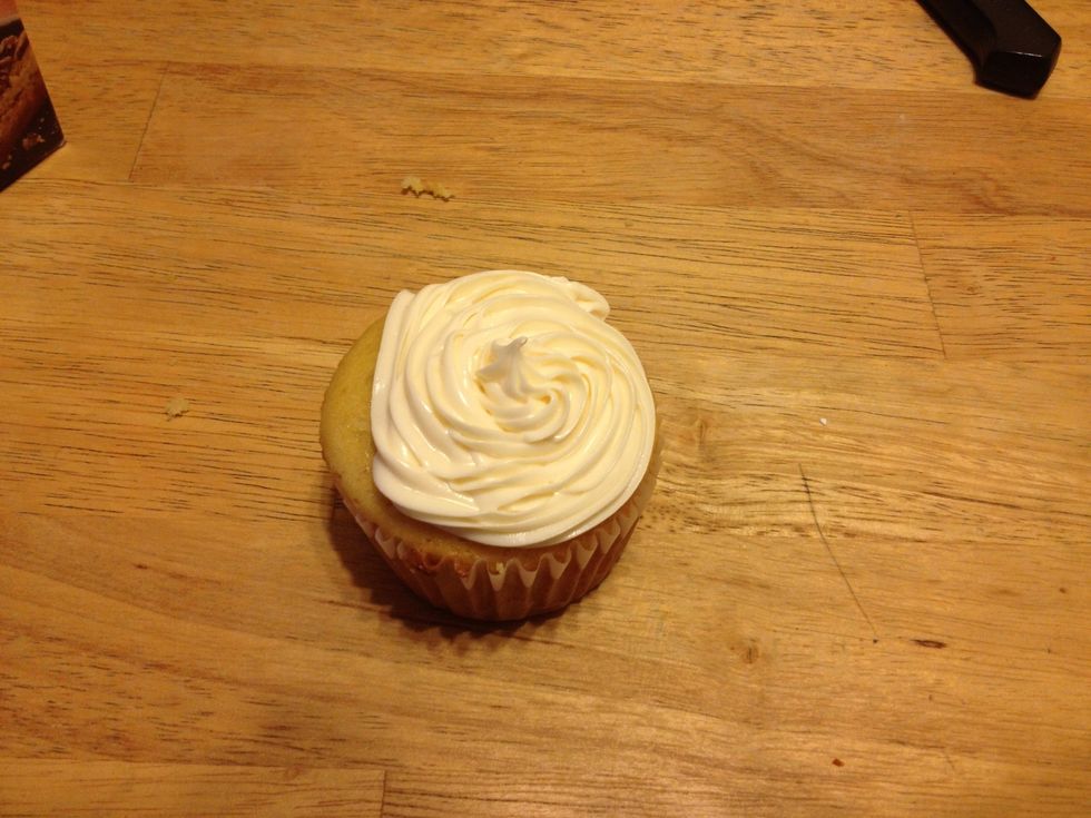 To help cut in deeper to get a better circle,then use the knife to take the top out,cut the top circle in half and the.Take the candy,put them in the empty circle and put the top back on the cupcake