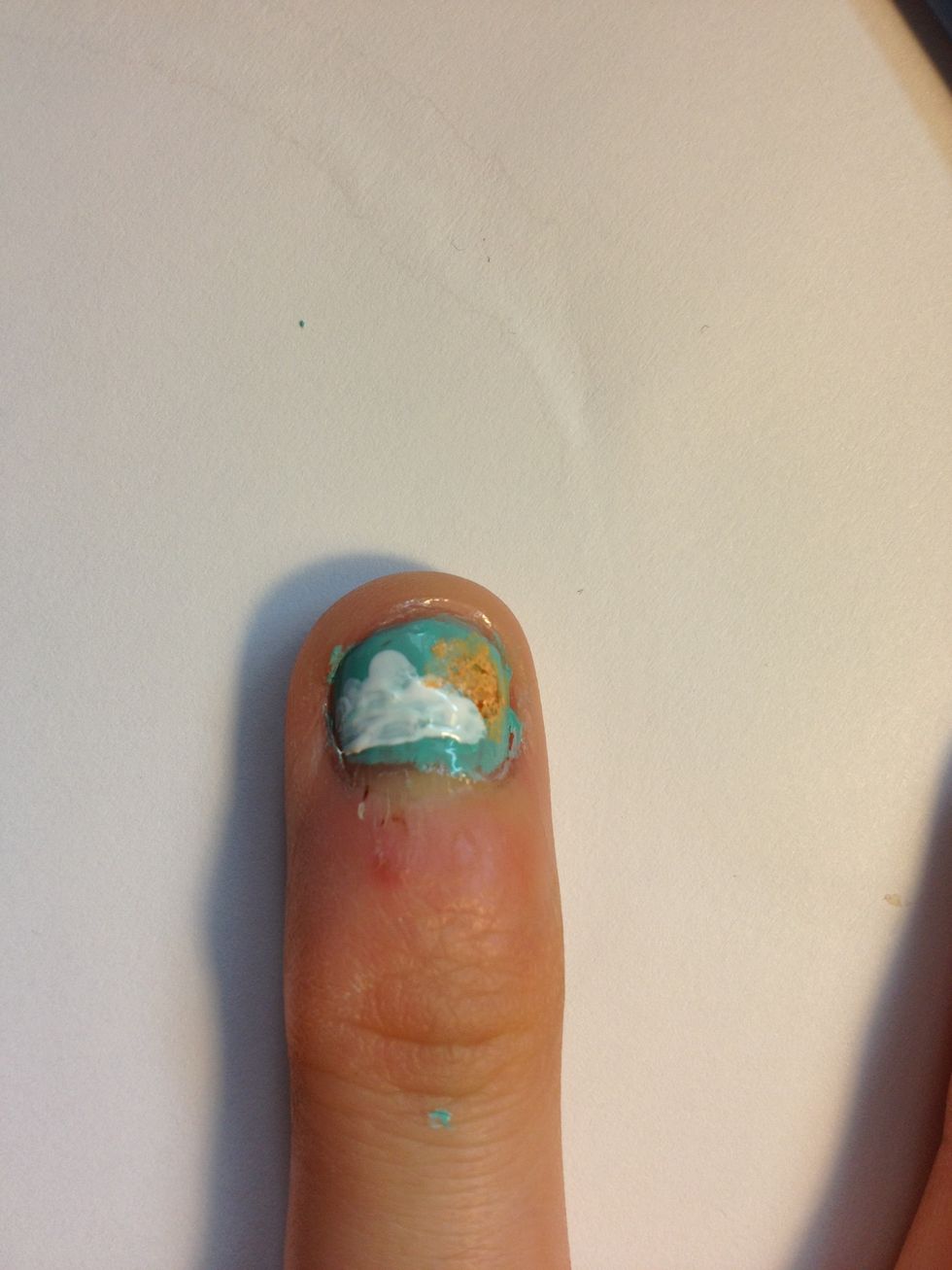 To make a sun, mix orange and white and dab that on your nail so it looks like it's behind the cloud.