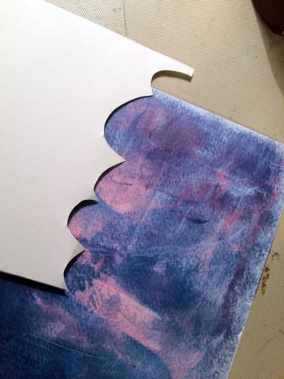 To make clouds on the background, I cut out a stencil out of cardstock.