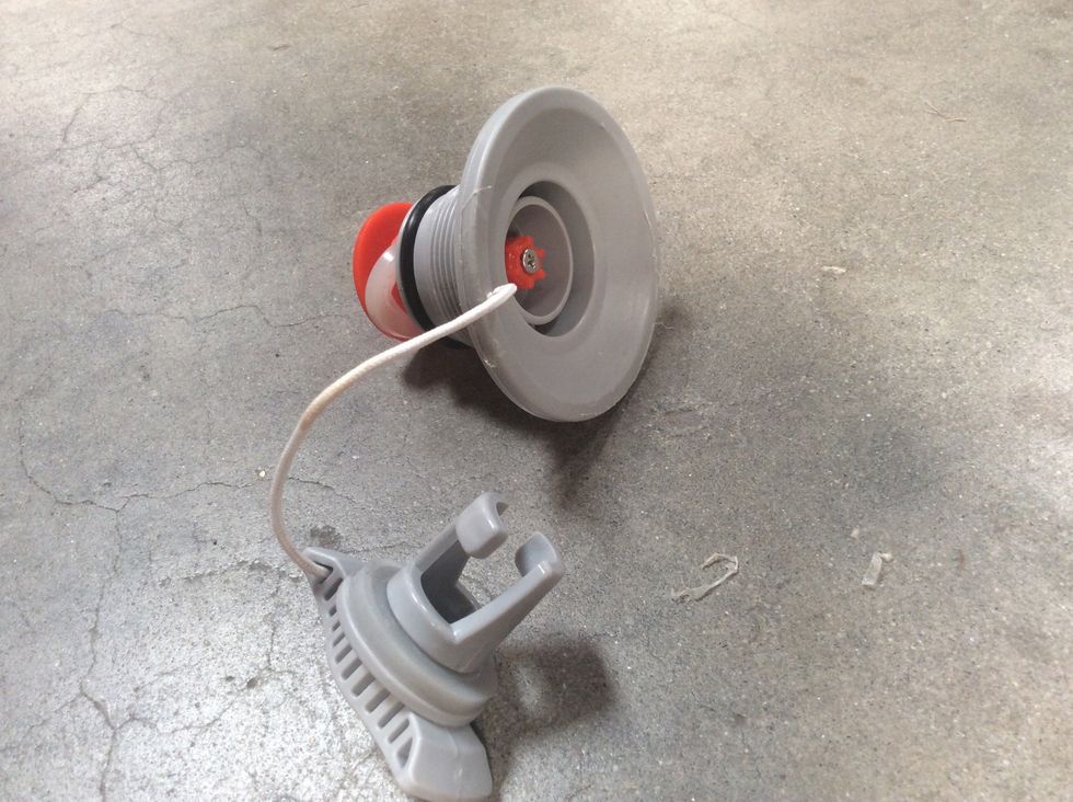 To make it easier to put the washer back in place, open up the valve by depressing the red nipple and turning one-quarter turn. This should lock the valve open.