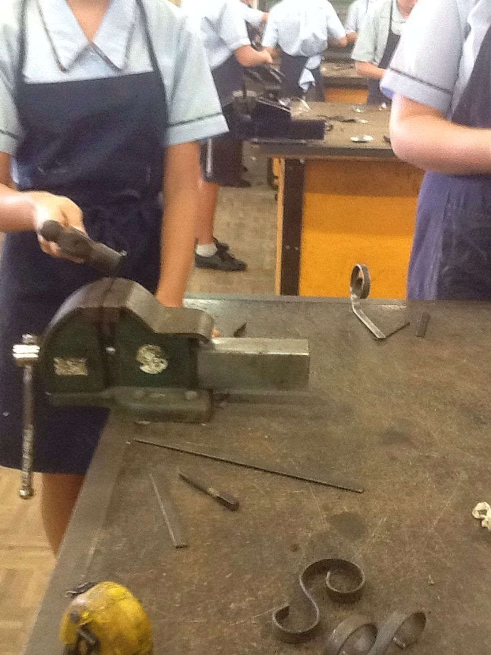 To make legs, use the ball pein hammer to hammer the shape of the legs.