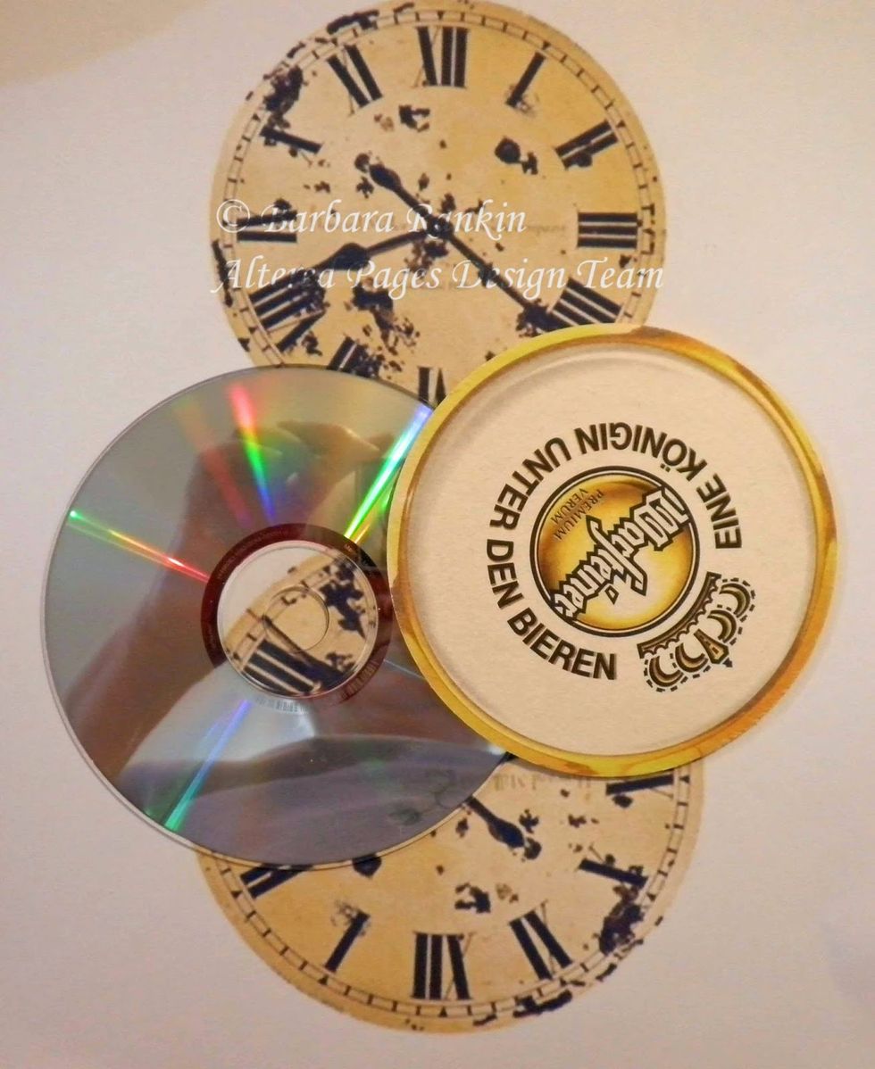 To make my clock, I first resized the clock face collage image to fit over the beer mat (coaster), cut out and adhered to the mat. Ink edge with Memento Luxe Peanut Brittle.