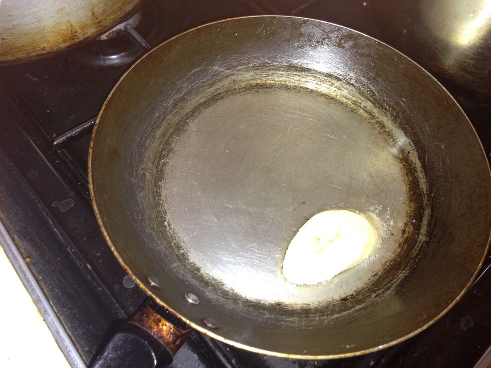 To make sure the frying pan is hot enough, place one plantain in the pan and when it sizzles, it's is hot enough, you should now turn it to medium heat