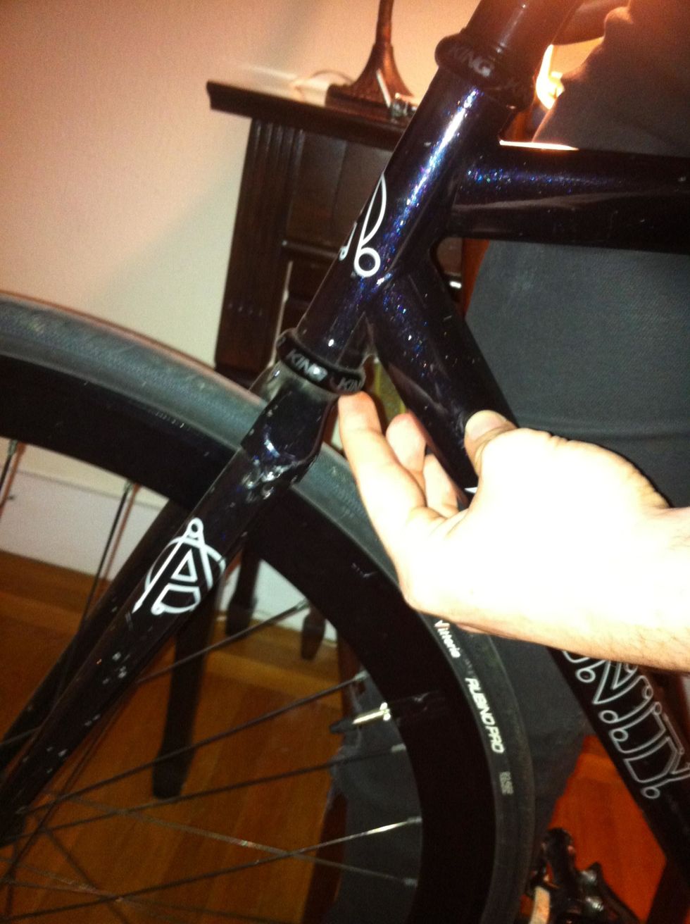 to make sure you tighten enough, place your finger at the where your fork enters the bottom of your steering tube where the crevice is. bounce your front wheel a couple of times. it should feel solid.