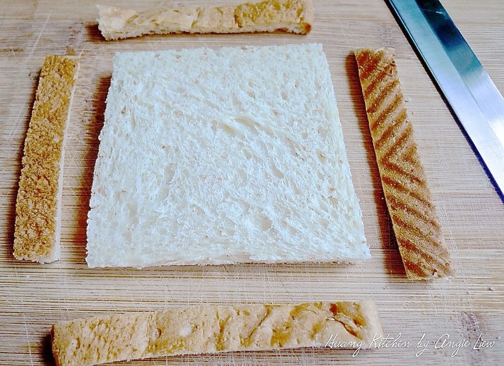 To make sushi sandwiches, first cut the crusts off of the whole wheat bread.