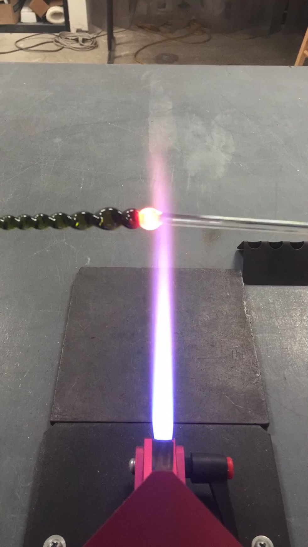 To make the loop, gather up a bit of the clear punty on the larger end of the icicle.