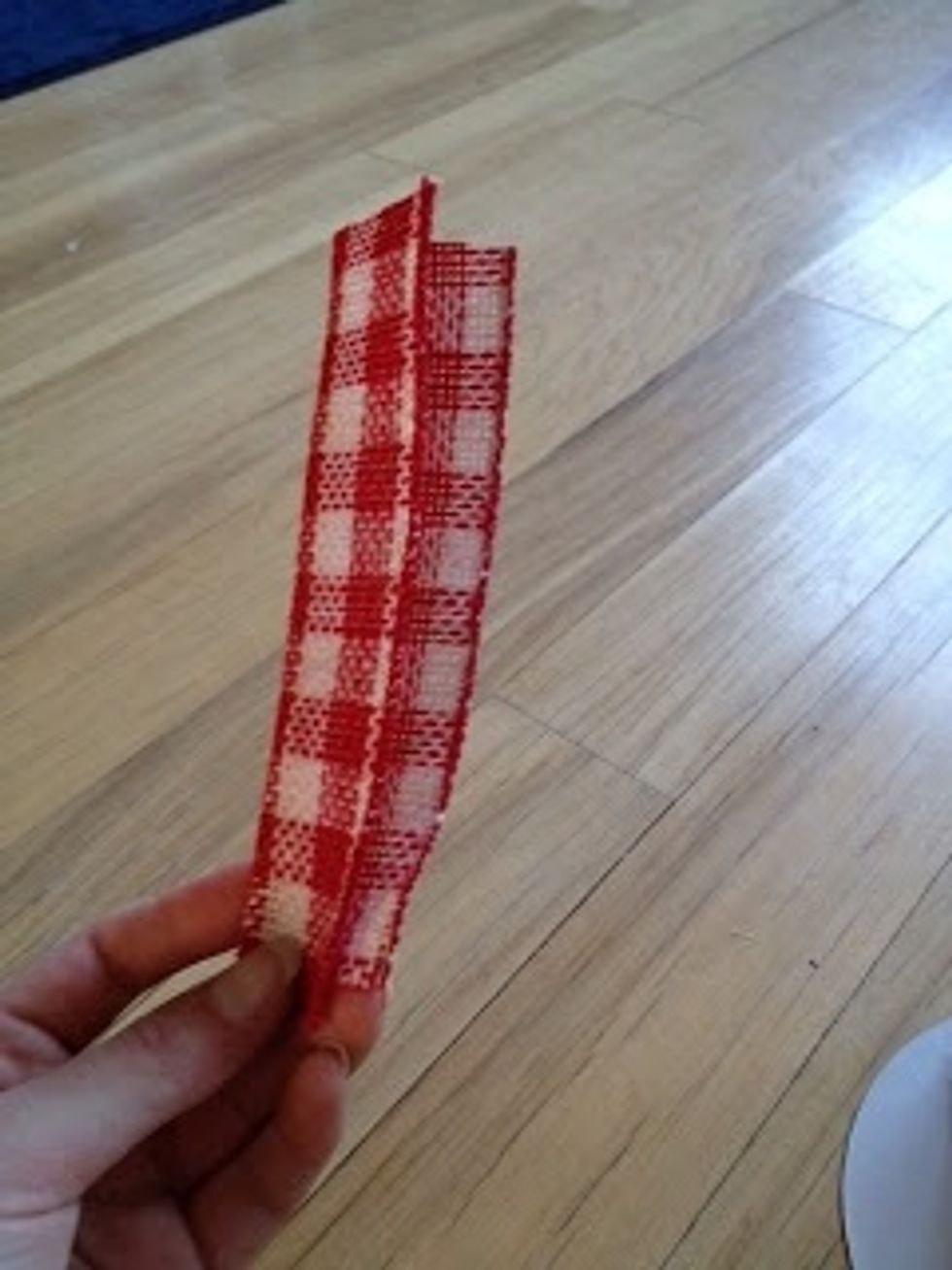 To make the rose, cut a 7" strip of burlap ribbon and fold in half.