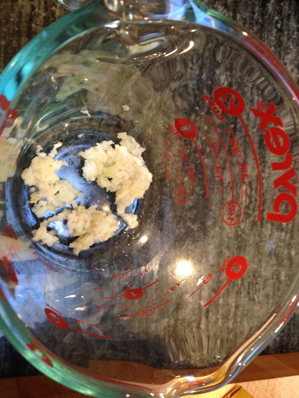 To make the sauce, combine the following ingredients in a small bowl: garlic, ginger, water, soy sauce, rice vinegar, honey, bouillon and sriracha. You can start by mincing the garlic cloves.