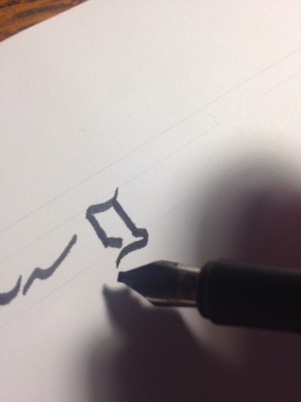 To make the stem, start a little ways inside that top stroke; make a straight stroke until you touch the bottom line, then curve outward. Finish it off by mimicking your top stroke, but reversed.