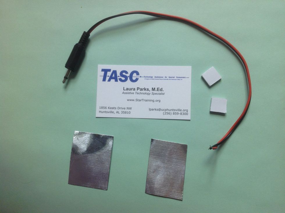 To make the switch, you will need the foil, business card, foam dots, and the plug with wire soldered.
