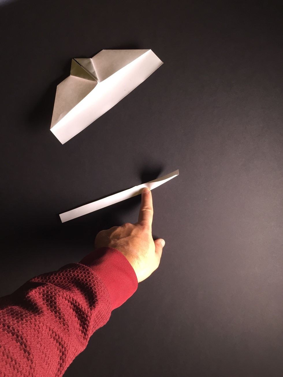 To make the tail, fold down the center of the strip of paper to form a trough.