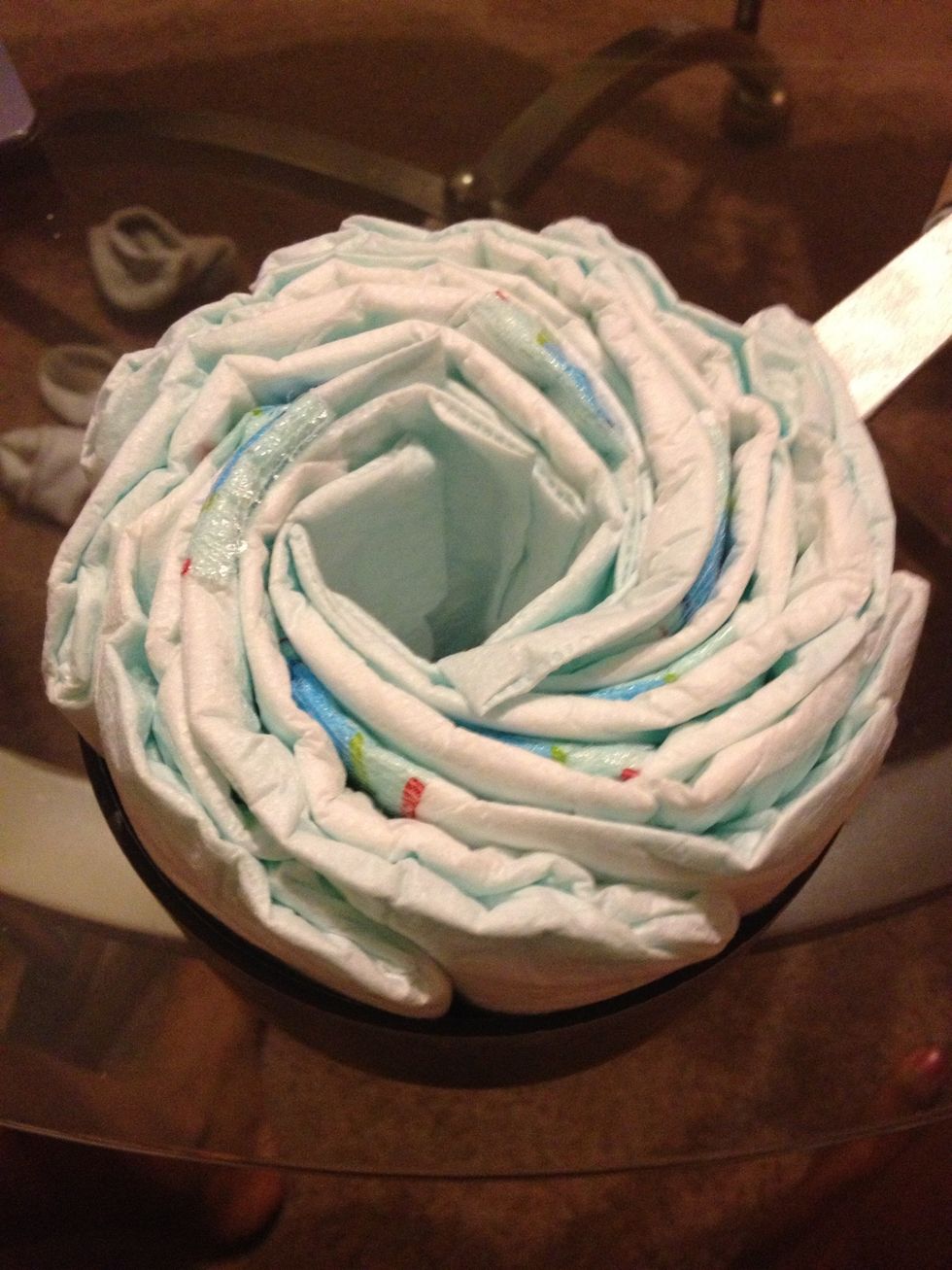 To make the wheels I used a small pot. I used 8 diapers for each wheel and this helped keep the shape. Put them in one by one and try to make it as uniform as possible then secure with a rubber band.
