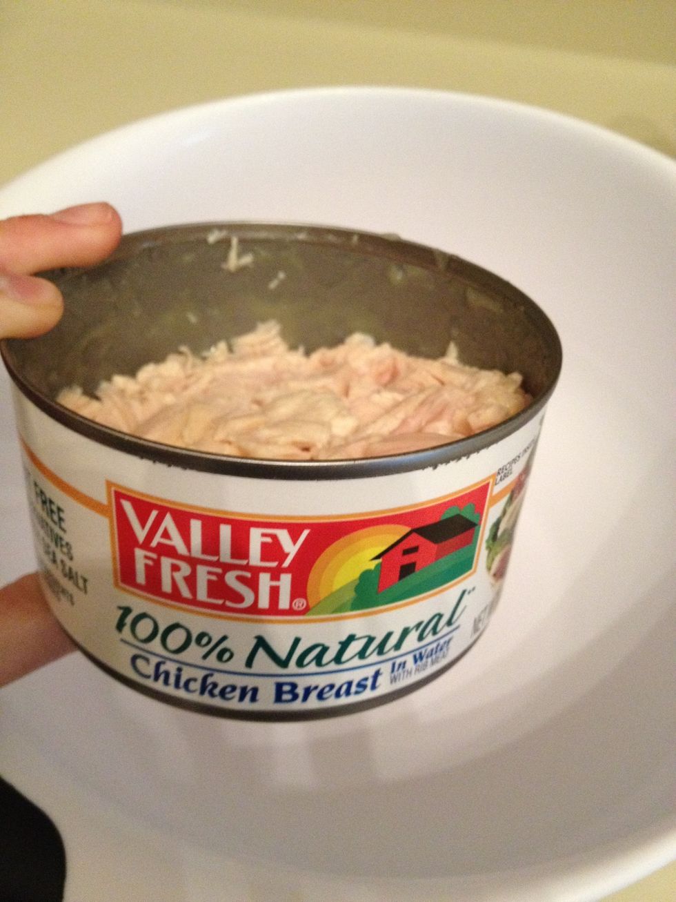 To make this Buffalo Chicken Dip quickly, use canned chicken breast. I use two 12.5 oz cans of 100% Natural Chicken Breast in water. Open, strain, and empty contents of cans into a large mixing bowl.