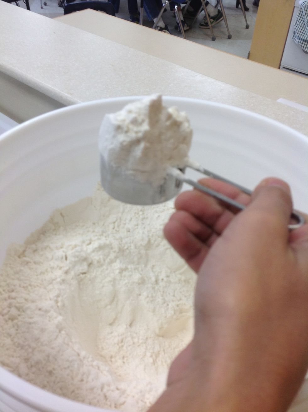 To measure solid and grainy things such as flour, use a standardized measuring cup. Remember to scoop more than you need.