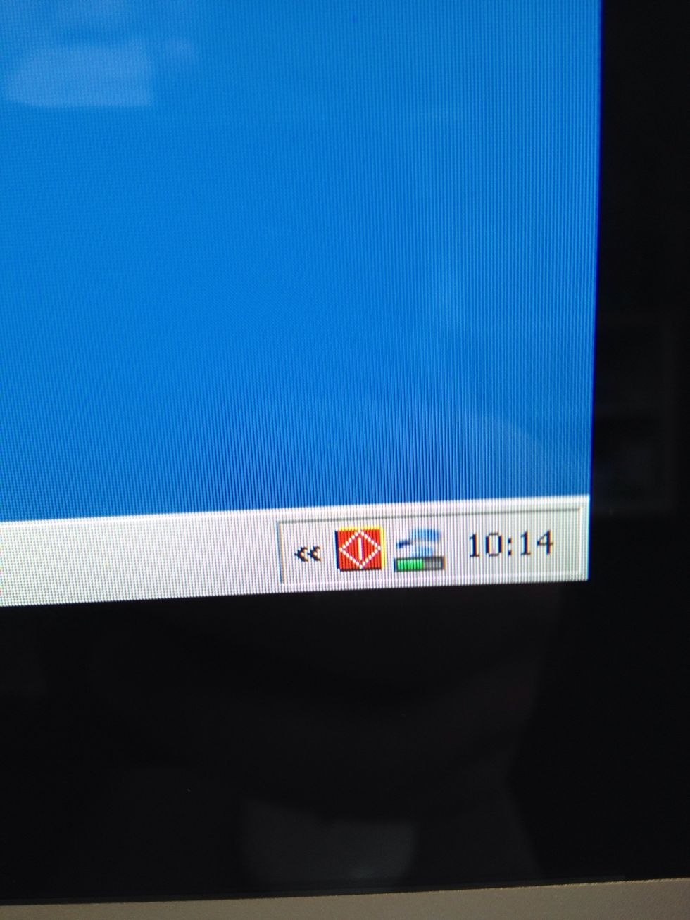 To open the laser cutter utility, click on the red and yellow logo down on the bottom right of the screen next to the clock.