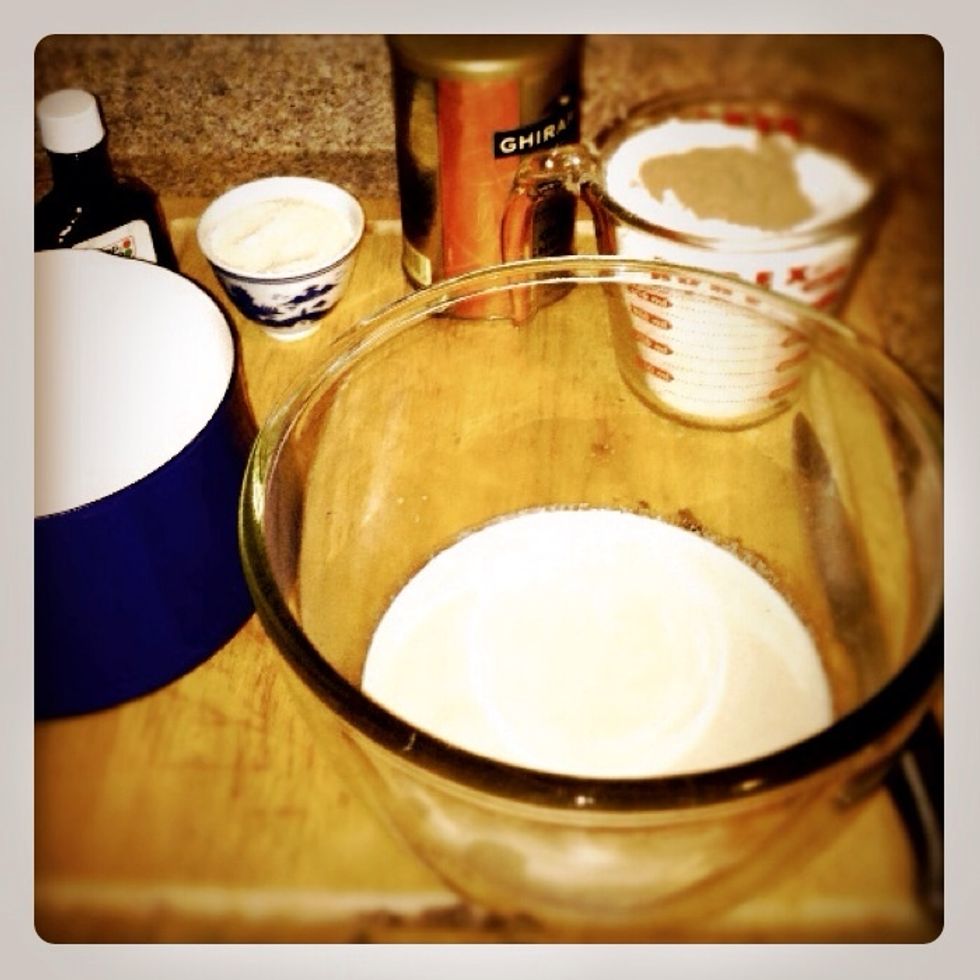 To our frothy milk add the rest of the sugar, egg, salt, and vanilla extract. Next stir in half of the flour and cocoa mix
