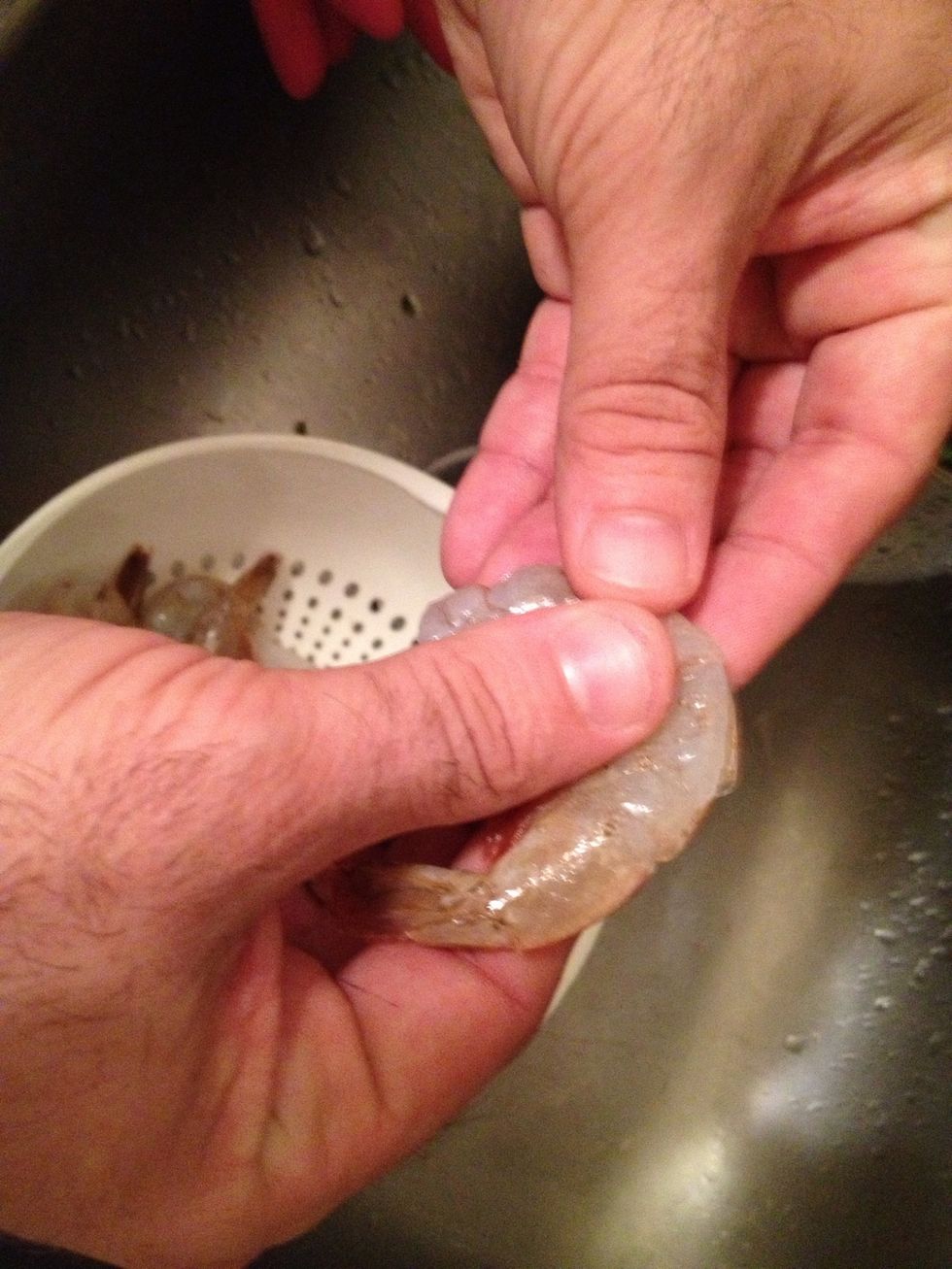 To peel the shrimp easily, hold the shrimp in two hands and between your thumb and forefingers.