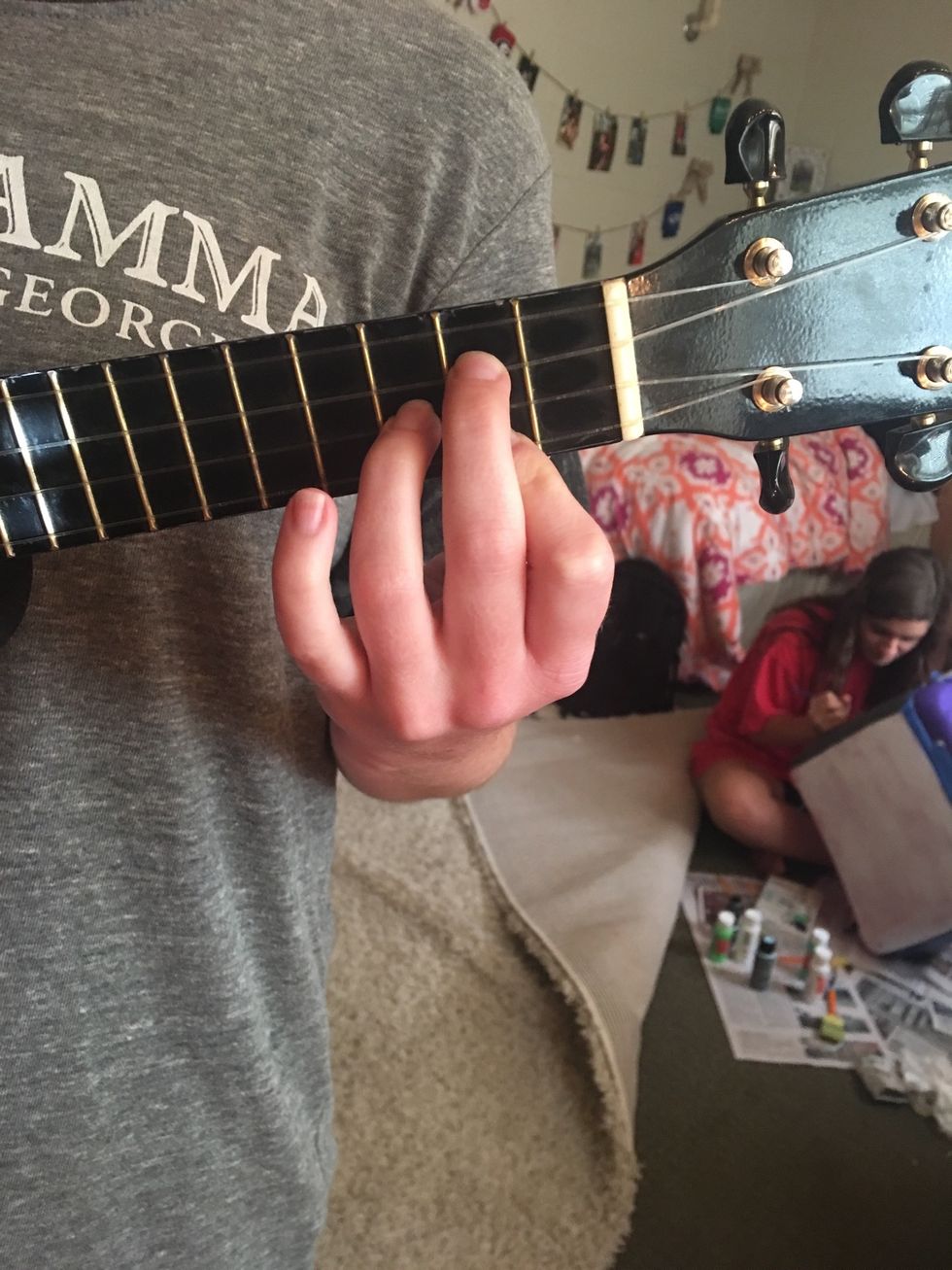 To play the G chord, you put your pointer finger on the bottom string, 2nd fret. Then, you put your middle finger on the 2nd string, 2nd fret. Last, place your ring finger on the 3rd string, 3rd fret.