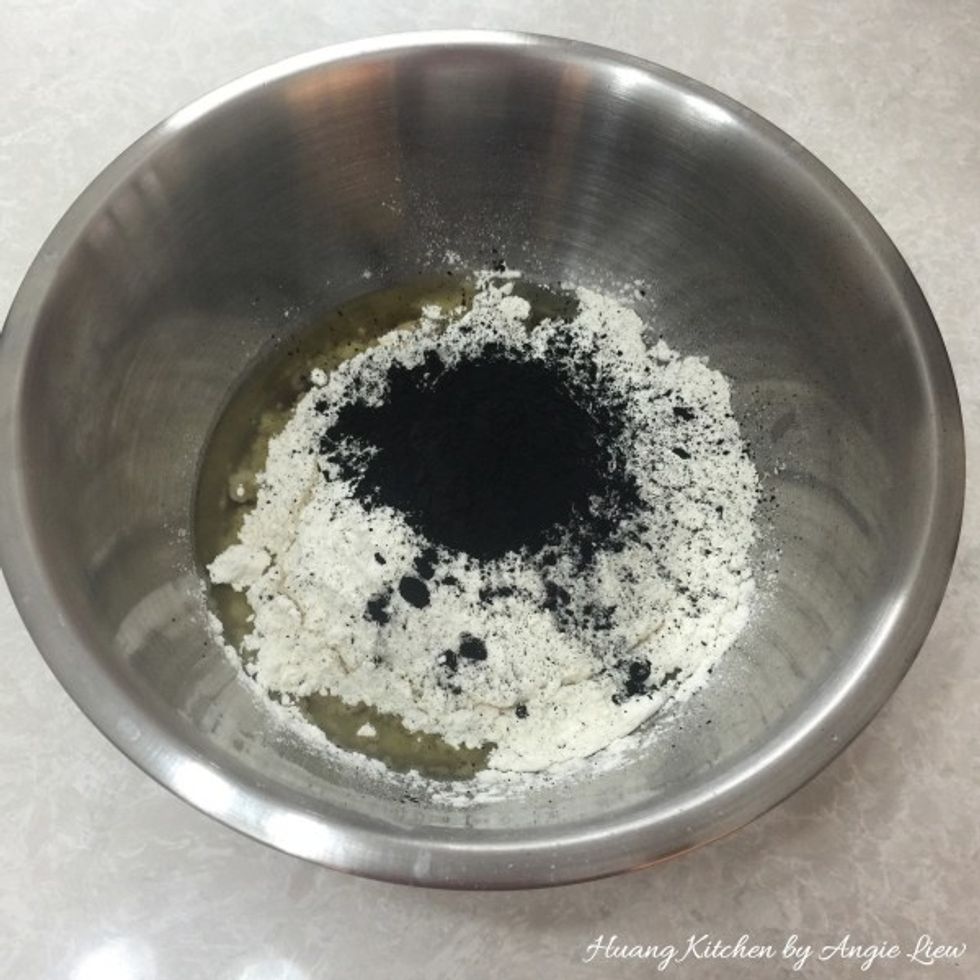 To prepare the mooncake skin, pour golden syrup followed by peanut oil, alkaline water, baking soda, flour and bamboo charcoal powder in a mixing bowl.