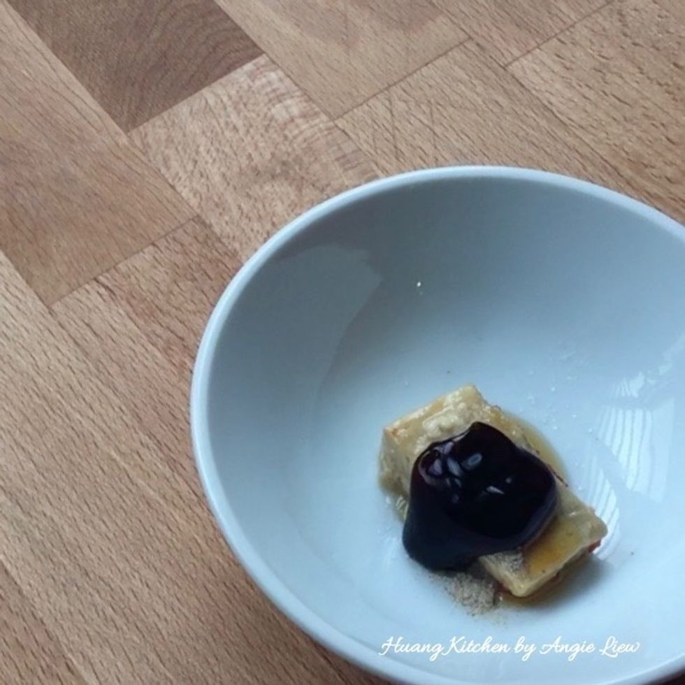 To prepare the sauce, first place fermented beancurd, ground white pepper, sesame oil and vegetarian oyster sauce in a bowl.
