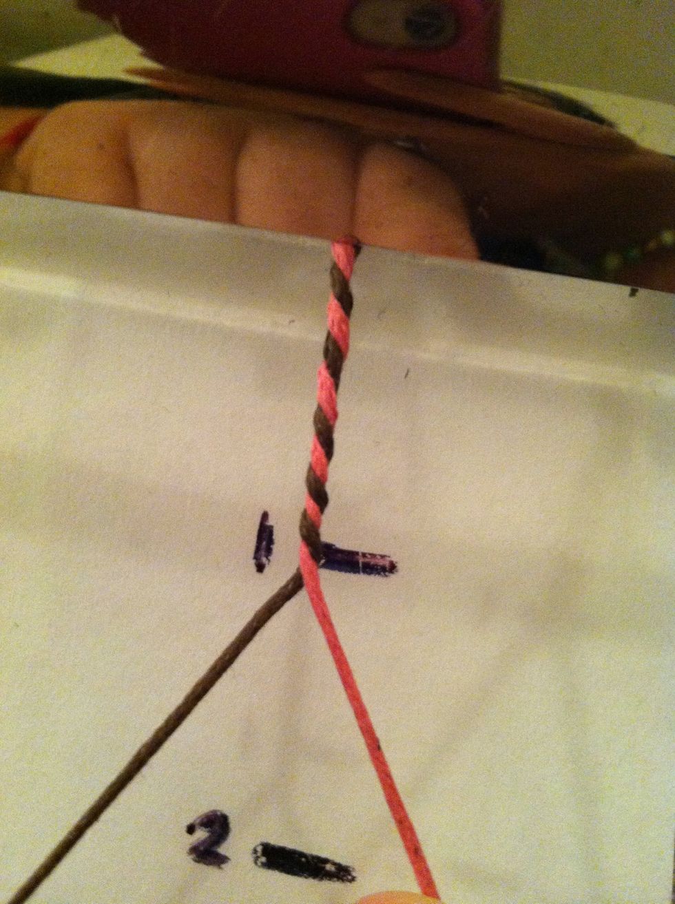 To properly twist them pull the cords away from each other, then pass then to the opposite side and pull tight again. Repeat till you are done and secure with an overhand knot.