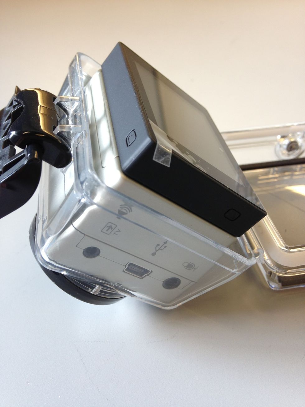 To put the camera in the waterproof case, place the camera lens side first into the case. Make sure the lens is lined up with the lens protector.