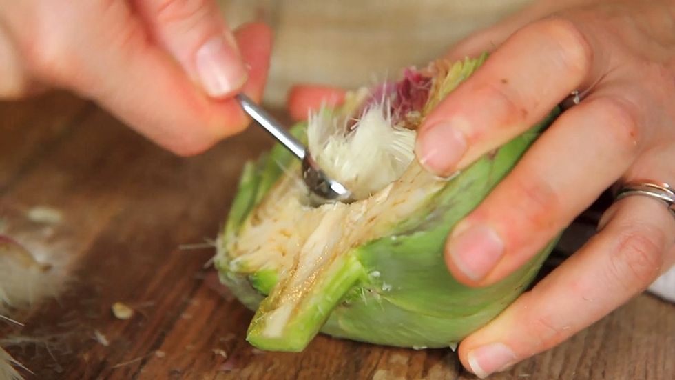 To remove the choke, gently spread apart the leaves, then pull out and discard the pale, thorny, innermost leaves. Use a spoon or melon baller to scrape out the choke.