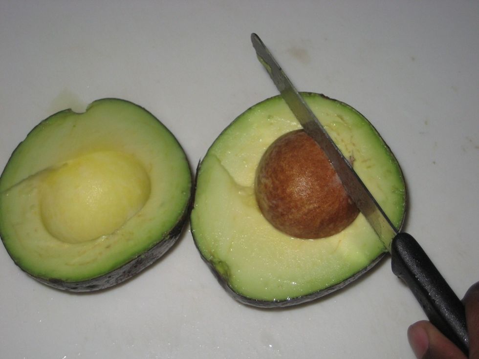 To remove the seed, firmly strike the seed with the knife then twist the seed til it moves out of place