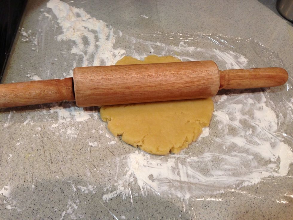 To roll, light flour dough and the counter and Roll out gradually. Remember to let the dough to rest for a moment before continuing. This will make rolling easier.