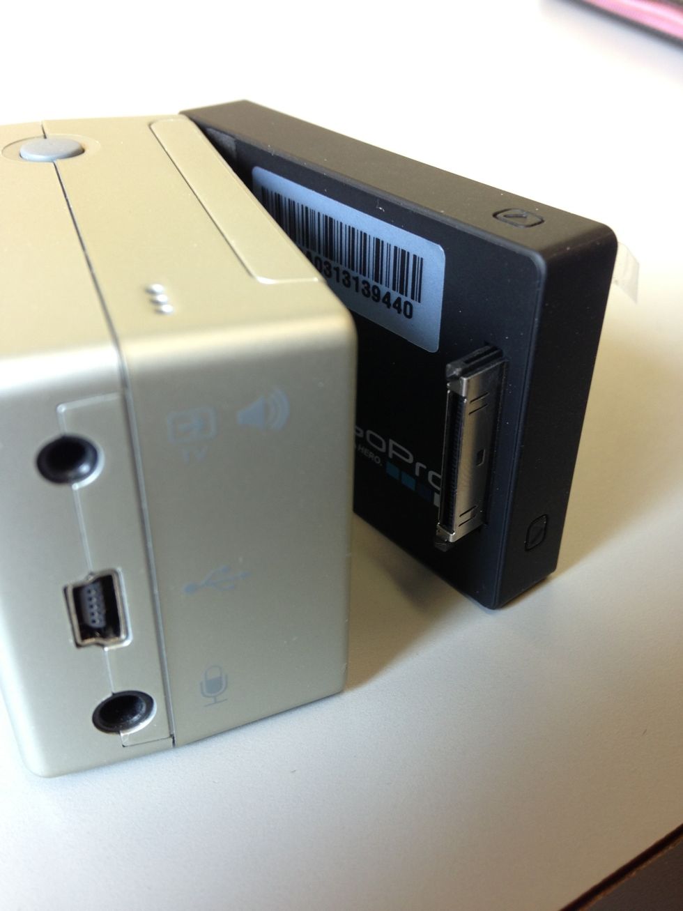 To separate the LCD screen from the camera, hold the camera while pulling the screen gently outwards from the side of the camera with the audio, USB, and mic connections.