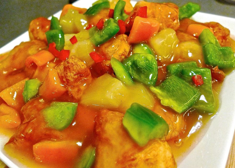 To serve, layer the cooked chicken, cut bell peppers and pineapple slices on a platter. Finally pour the sauce over the chicken. Serve with rice.