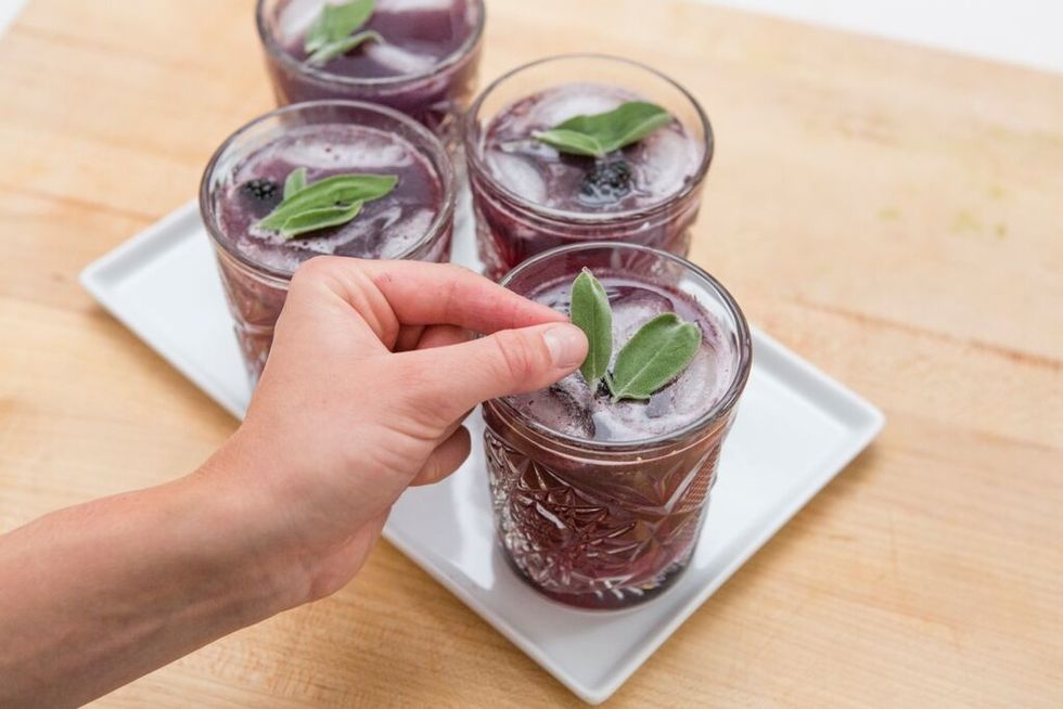 To serve, place a tablespoon of the blackberry puree in the bottom of a glass. Then, add a tablespoon of the sage syrup and top off with 8 ounces of club soda. Serve with ice.