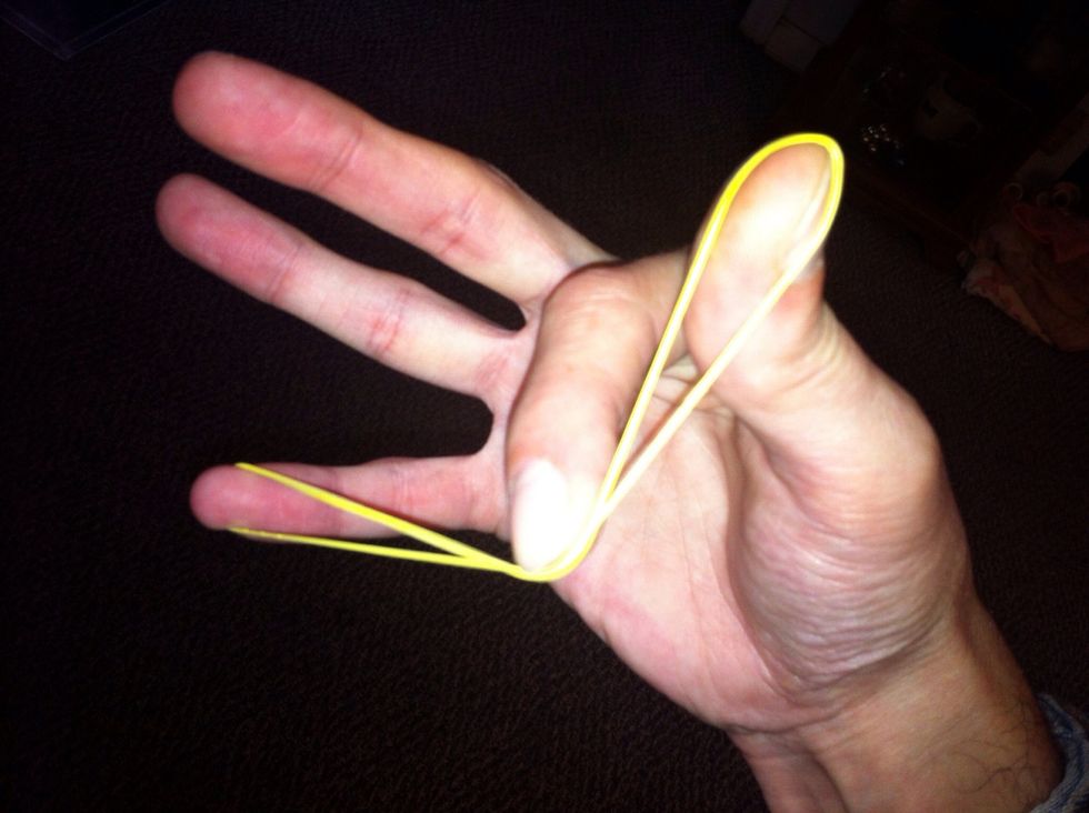 To shoot. Push down on both bands with your index finger. Push down hard to get more distance. Allow the band to snap off your thumb first.