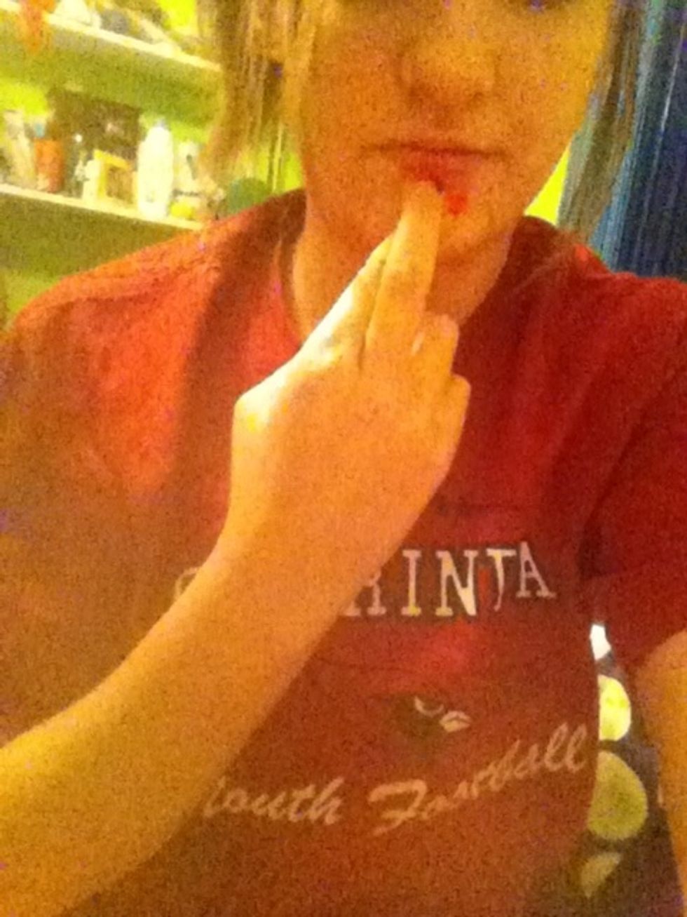 To sign "red," cross your index & middle fingers, touch your index finger to your chin, & drag it down the middle of your chin.